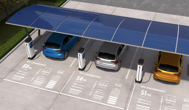 Solar carport with panels overhead and electric cars charging in the bays beneath it