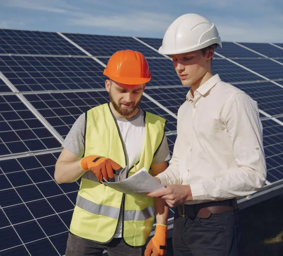 Engineer and client discussing a solar proposal onsite