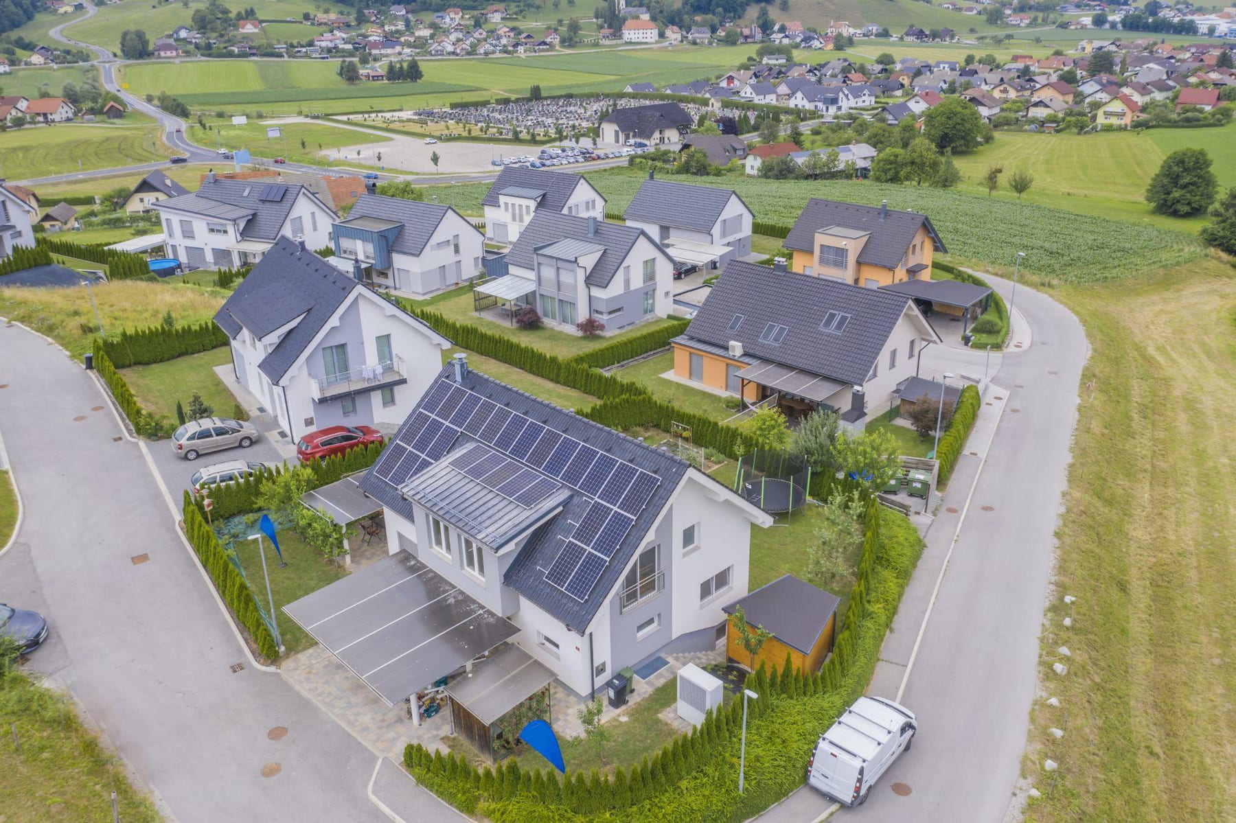 Aerial view of a suburban street of homes with rooftop solar panels