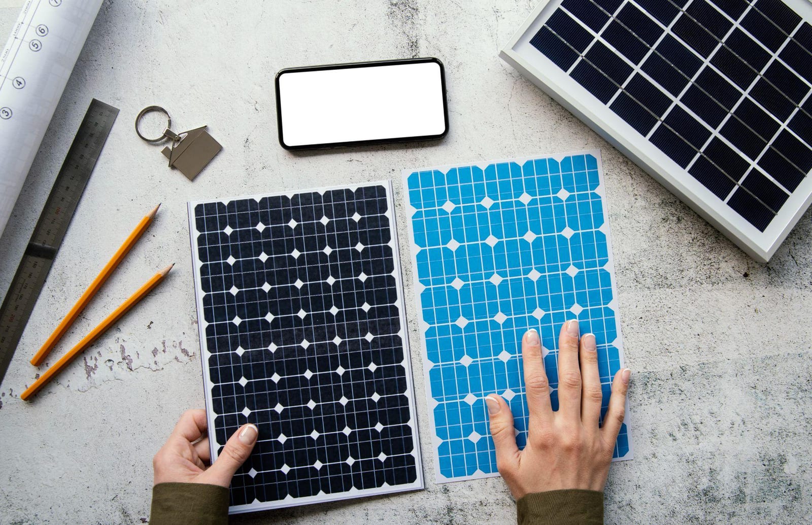 Two solar panel samples, one monocrystalline and one polycrystalline, laid out with measuring tools
