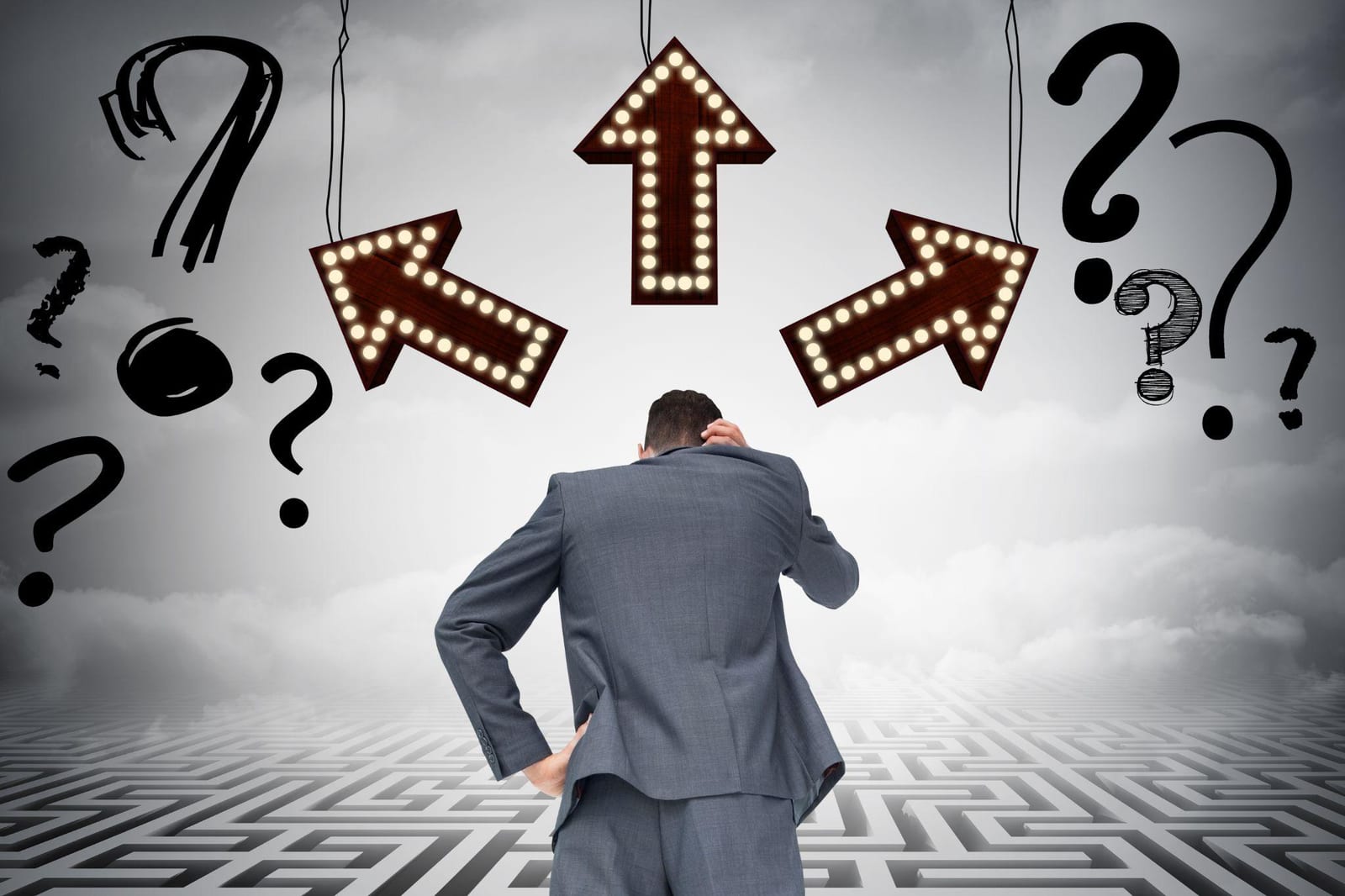 A person in a suit standing on a maze looking up at arrows and question marks