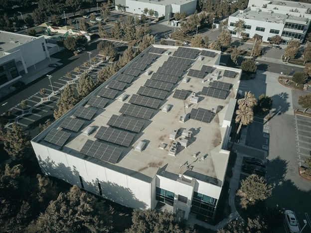 Commercial solar panels installed across a warehouse roof
