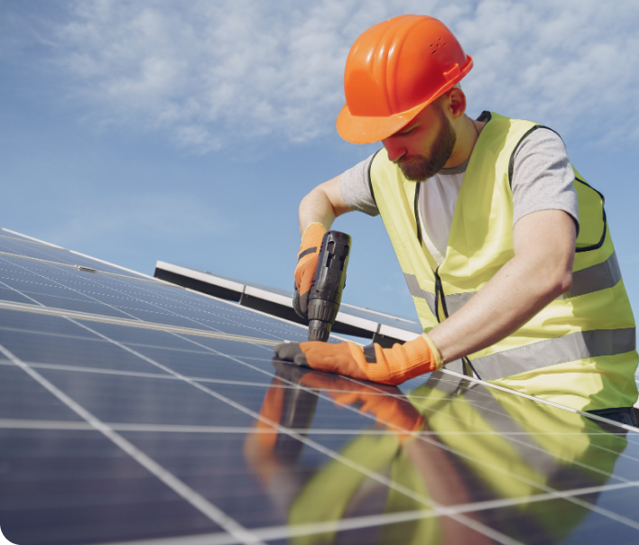 Engineer fixing a solar panel in place on a rooftop array