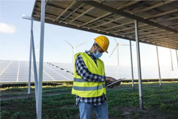 Engineer reviewing energy data on a tablet during an audit